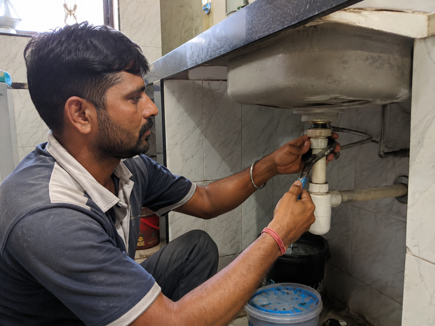 Local plumber repairing a sink pipe for a residential customer in Chatsworth, Durban